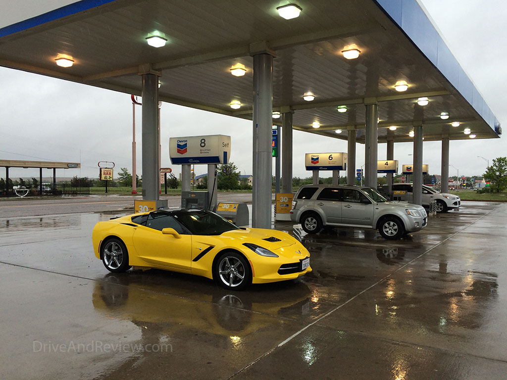 yellow c7 corvette at the gas station