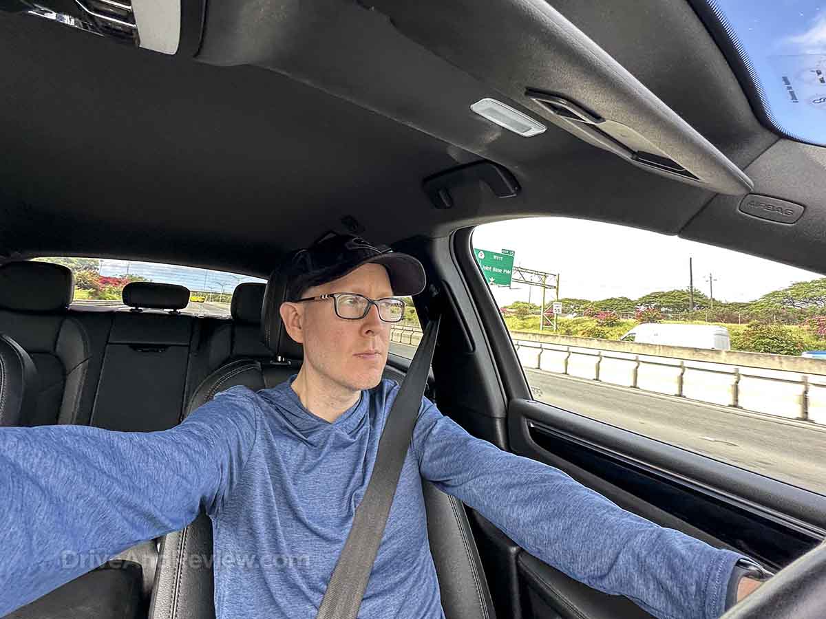 Scott from DriveAndReview sitting in a Porsche Macan