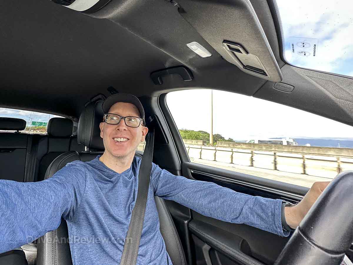 Smiling while driving a Porsche Macan