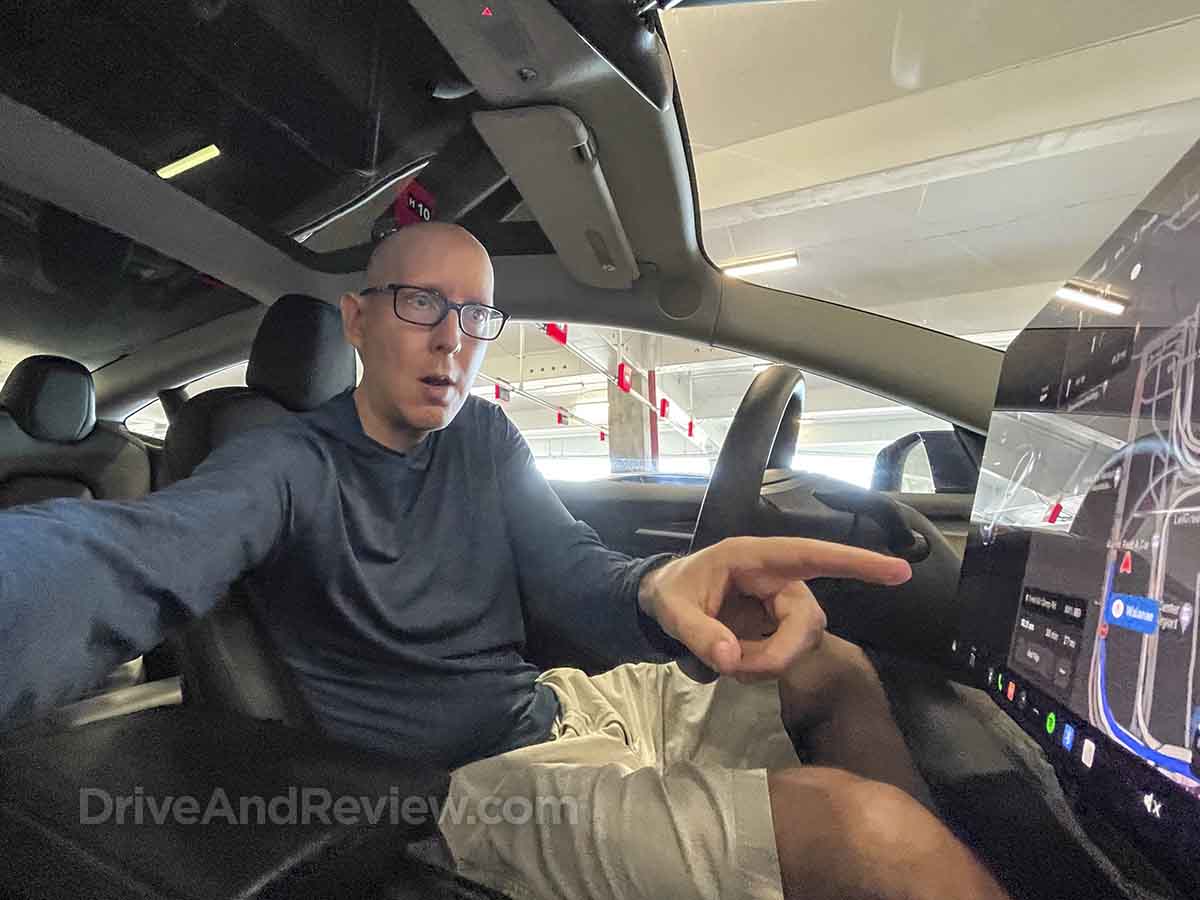 Scott interacting with the touchscreen in the 2023 Tesla Model 3