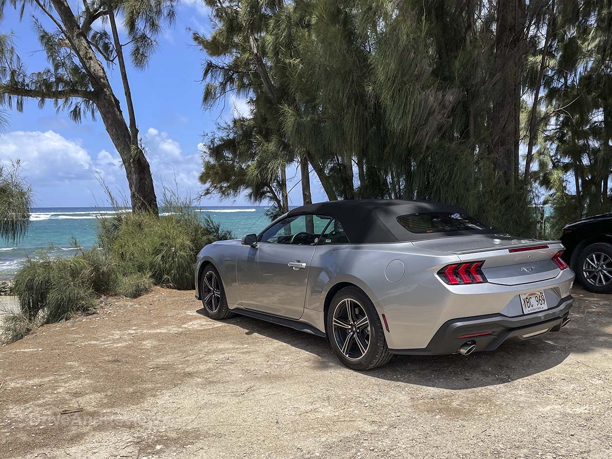 Silver 2025 Ford Mustang convertible parked at the beach in Hawaii