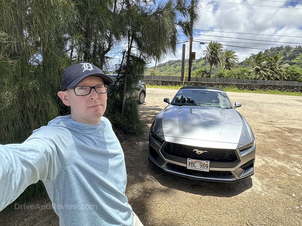 Scott standing in front of a silver 2025 Ford Mustang convertible