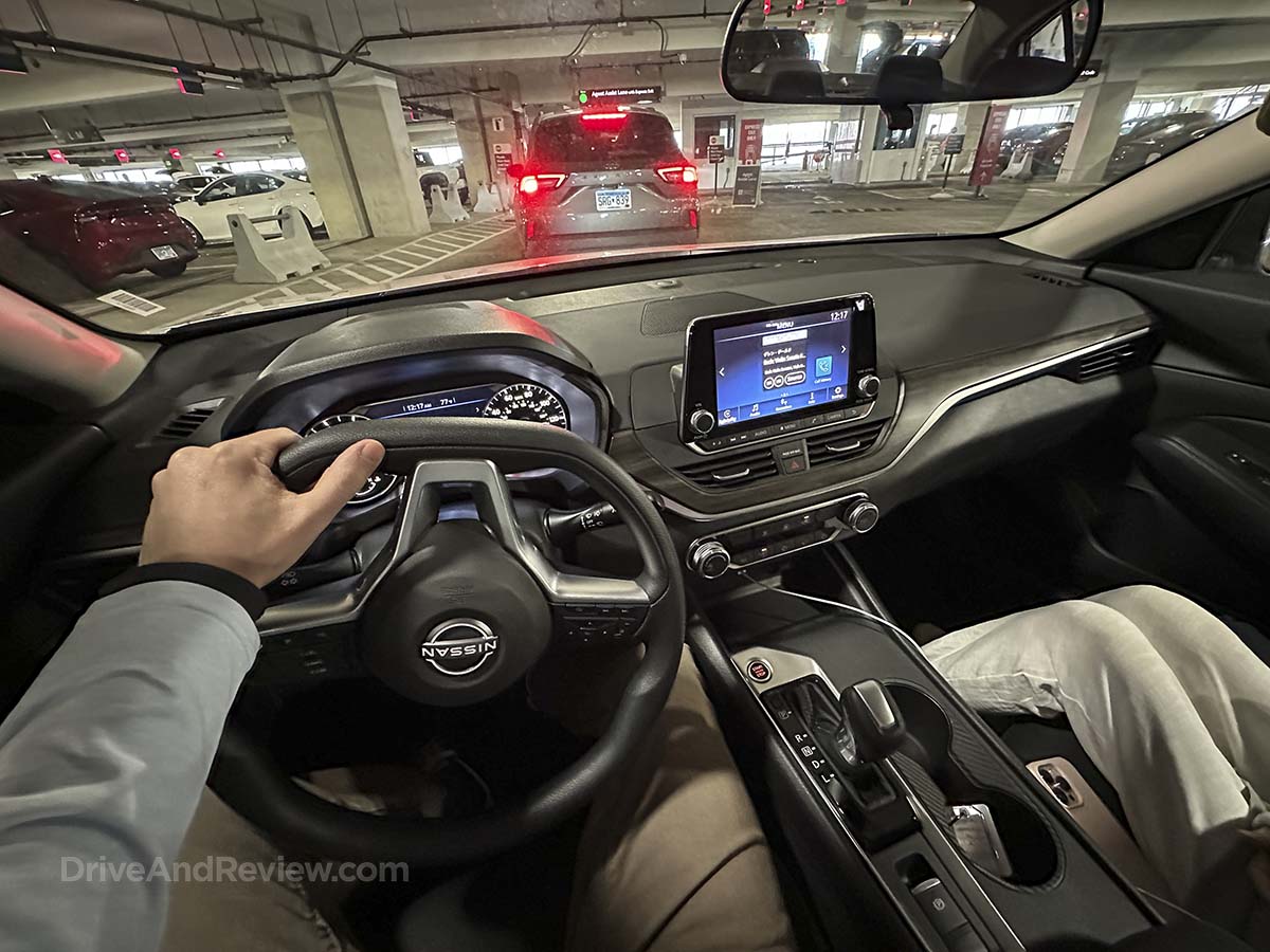 Driving a 2026 Nissan Altima out of the rental car parking garage for the very first time