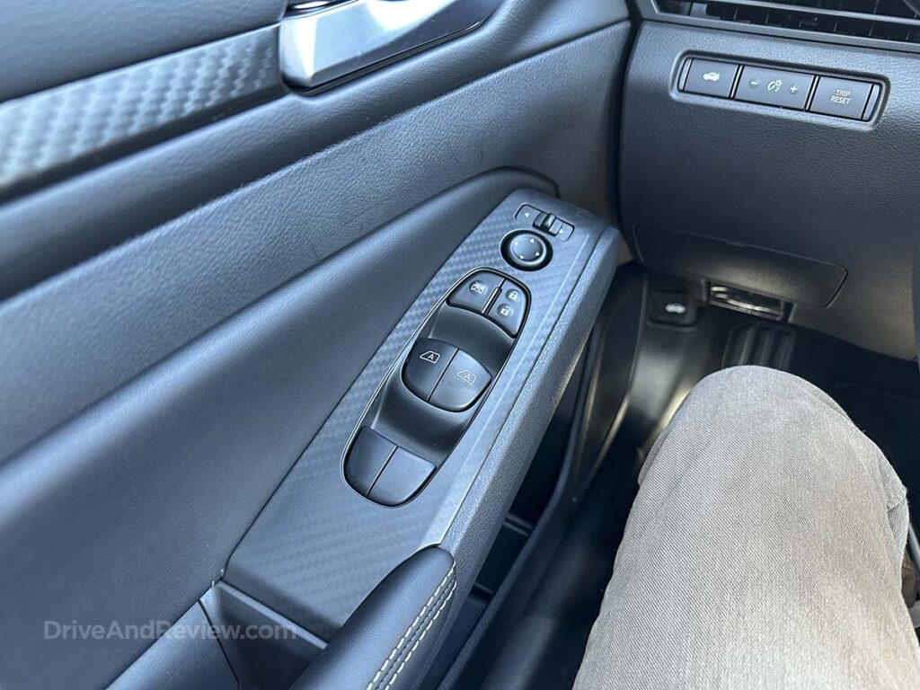 2026 Nissan Altima power window and power lock buttons in the armrest on the door panel