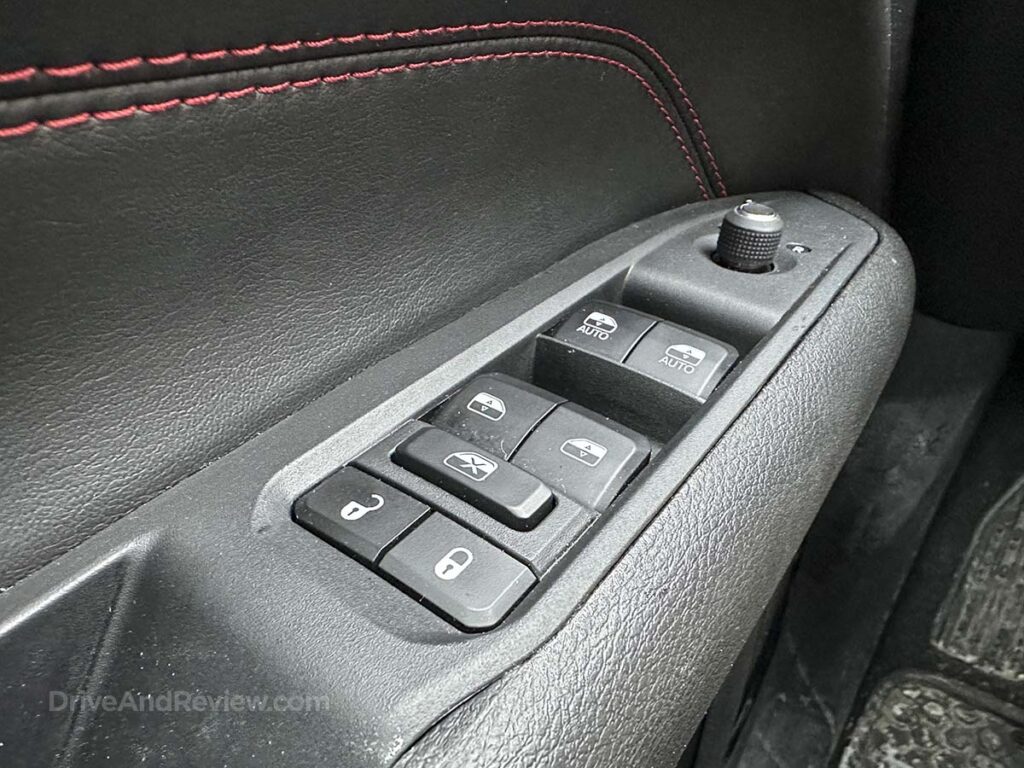 2025 Jeep Compass Trailhawk power window controls in driver-side armrest