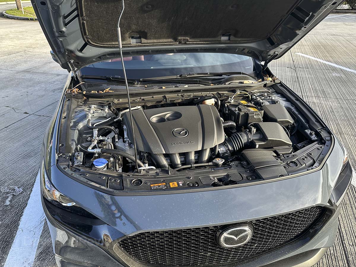 2026 Mazda 3 with the hood open showing it's 2.5 L SKYACTIV-G engine