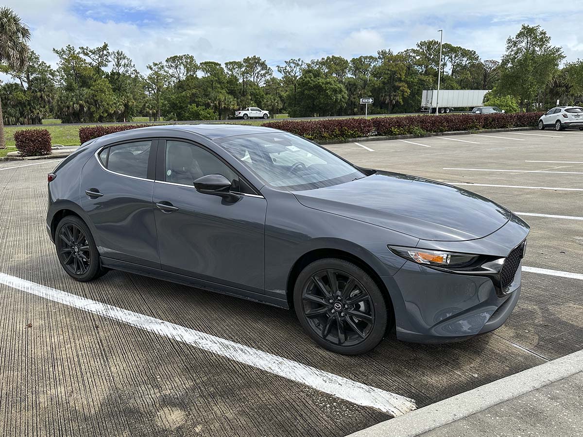 Gray 2026 Mazda 3 with black wheels front 3/4 view