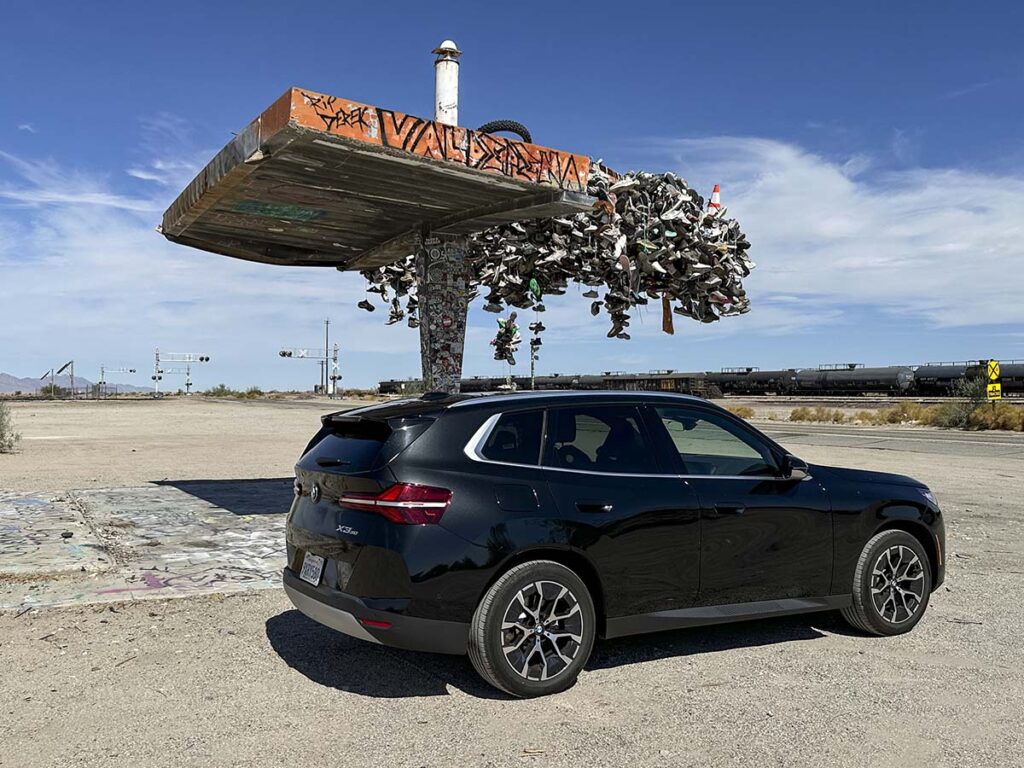 Black 2026 BMW X3 30 xDrive parked next to a roadside landmark in Earp, CA