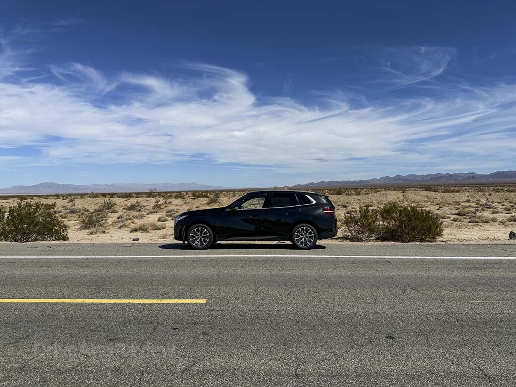 All black 2026 BMW X3 30 xDrive parked on the side of the road and the California desert
