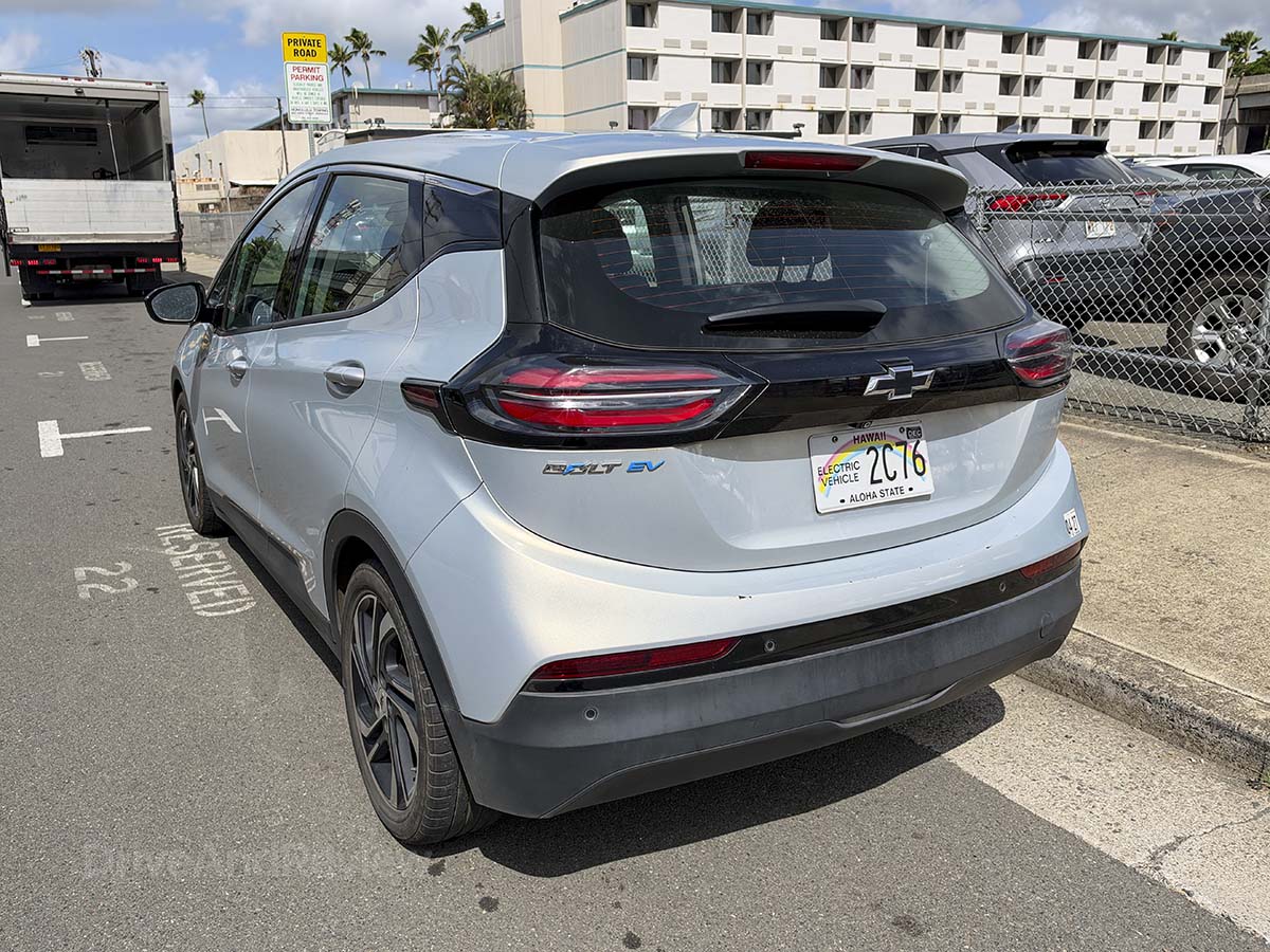 Silver 2024 Chevy Bolt EV rear 3/4 view showing tail lights and rear window