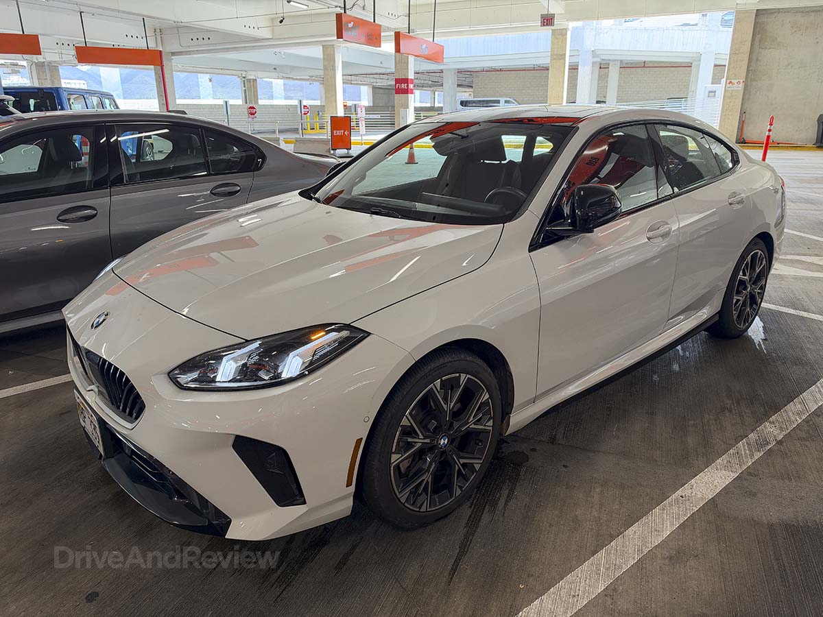 White 2026 BMW 228 xDrive parked at the Sixt rental car garage Honolulu airport