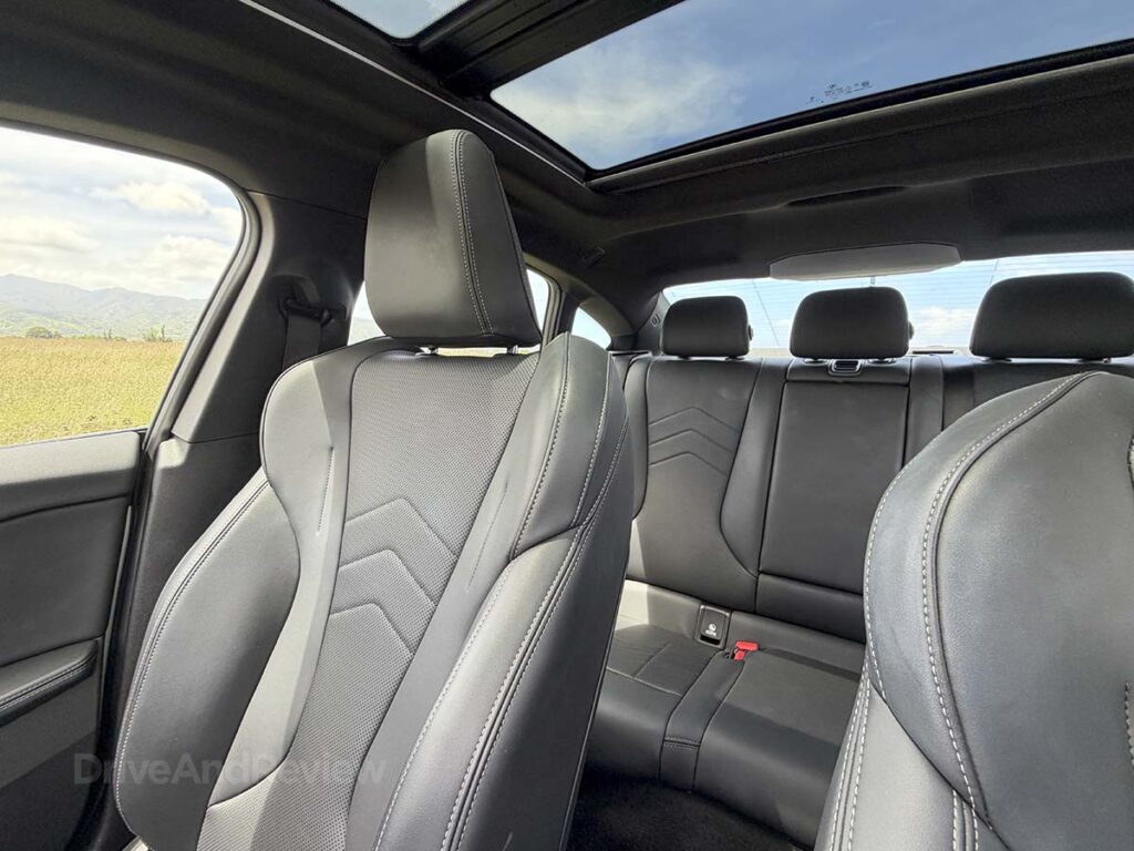 2026 BMW 228 black interior showing headrests in the seats and open sunroof