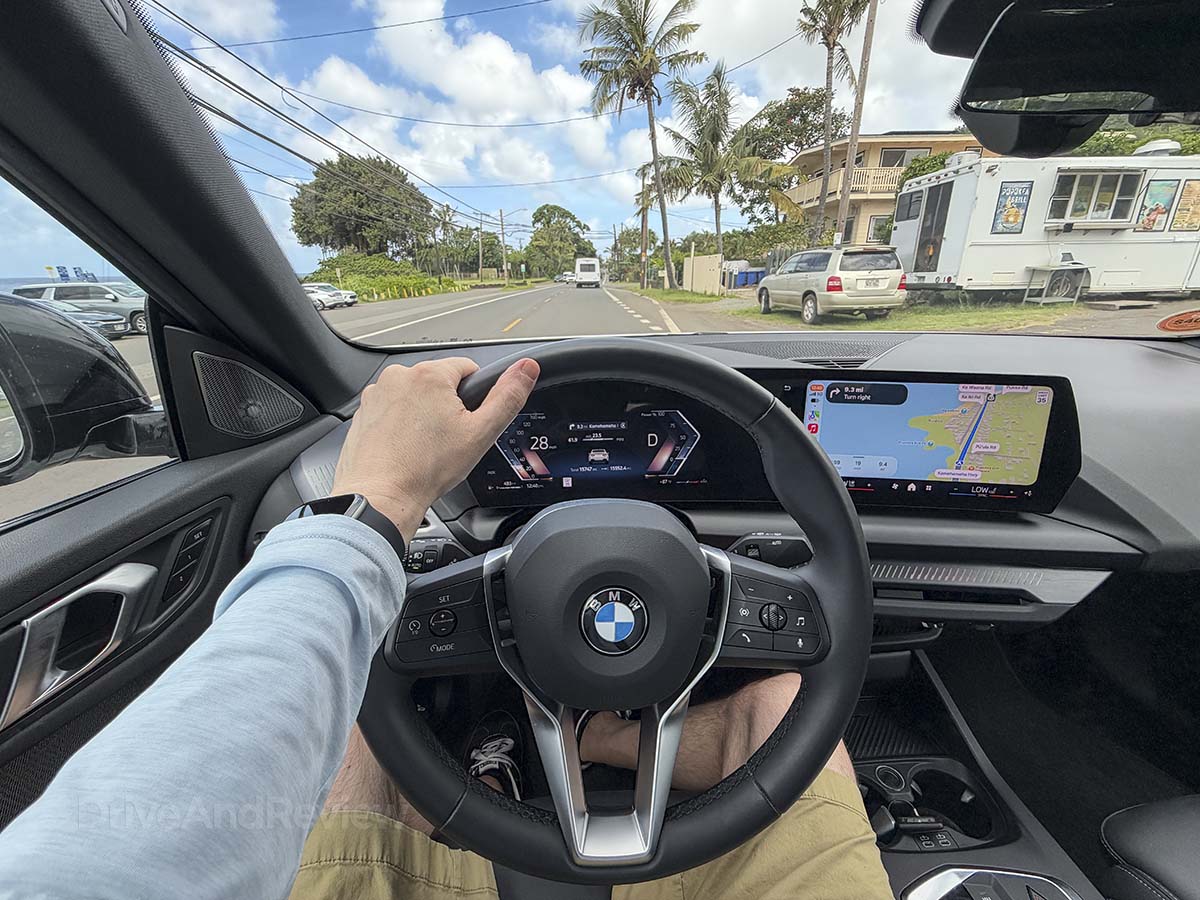 POV driving a 2026 BMW 228 on city streets in Hawaii