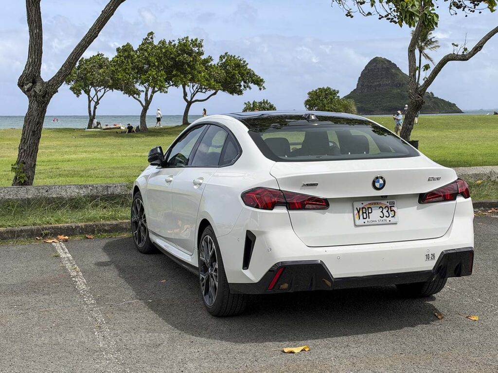 White 2026 BMW 228 xDrive parked at the beach in Hawaii